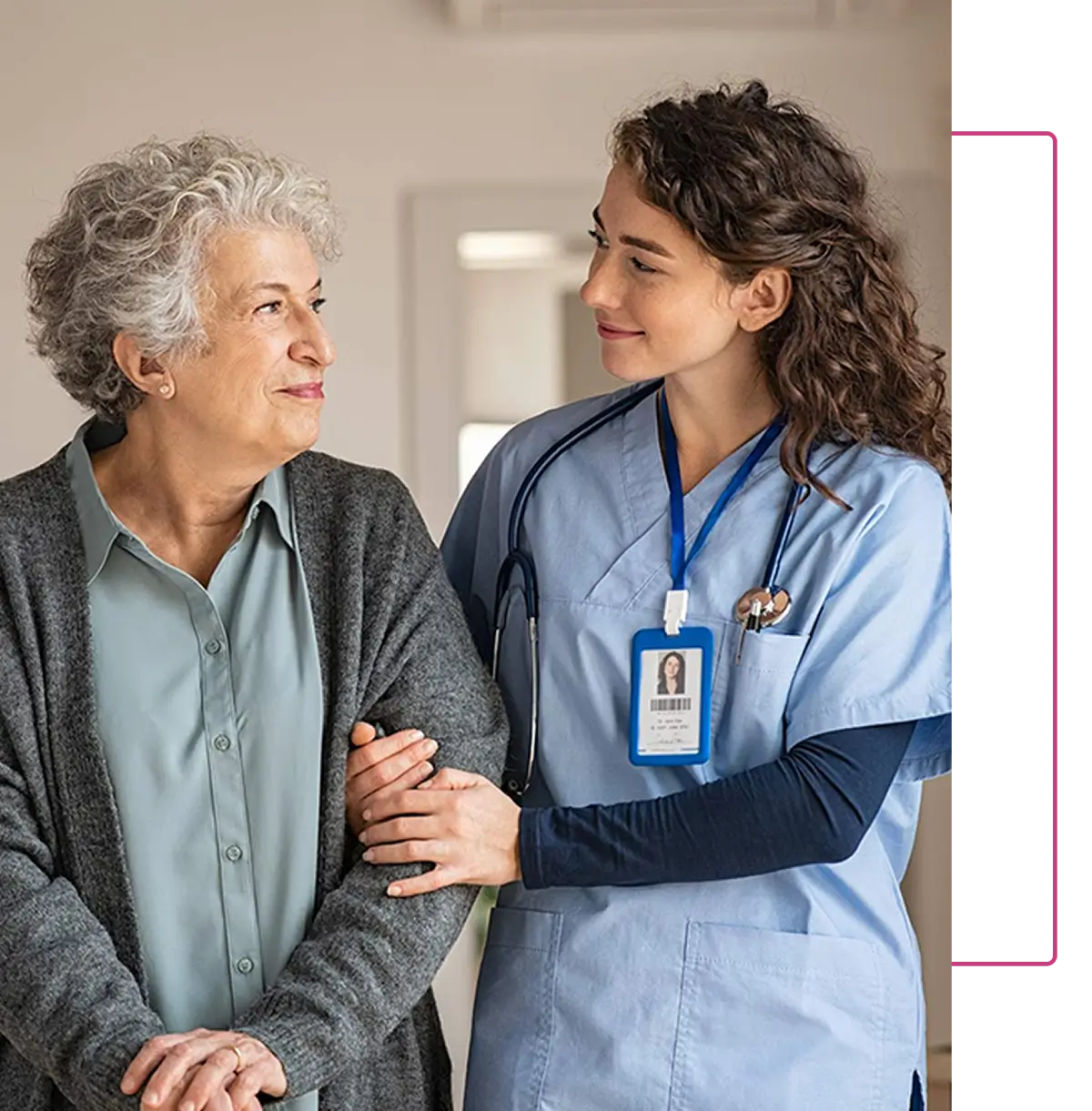 Smiling nurse supporting elderly woman